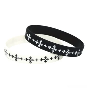 Black and white gothic cross silicone wristbands flat lay overhead view with hidden safety clasp
