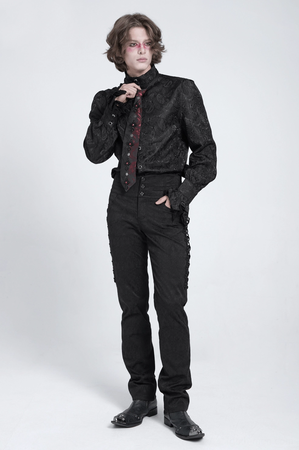 Gothic crystal cross necktie with red gemstone focal point and black rose jacquard background, styled detail view