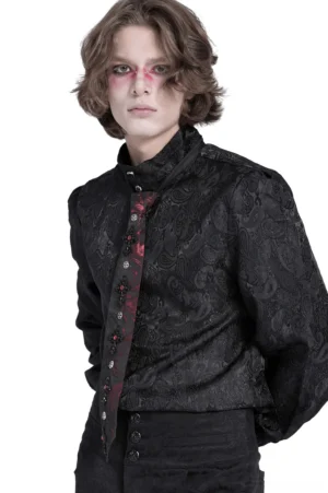Gothic necktie styled with black jacquard dress shirt on male model with gothic makeup, side full-body view