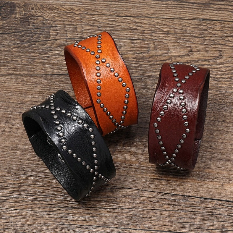 All three gothic leather cuff bracelet colors displayed flat - black, brown, and wine red with geometric rivets