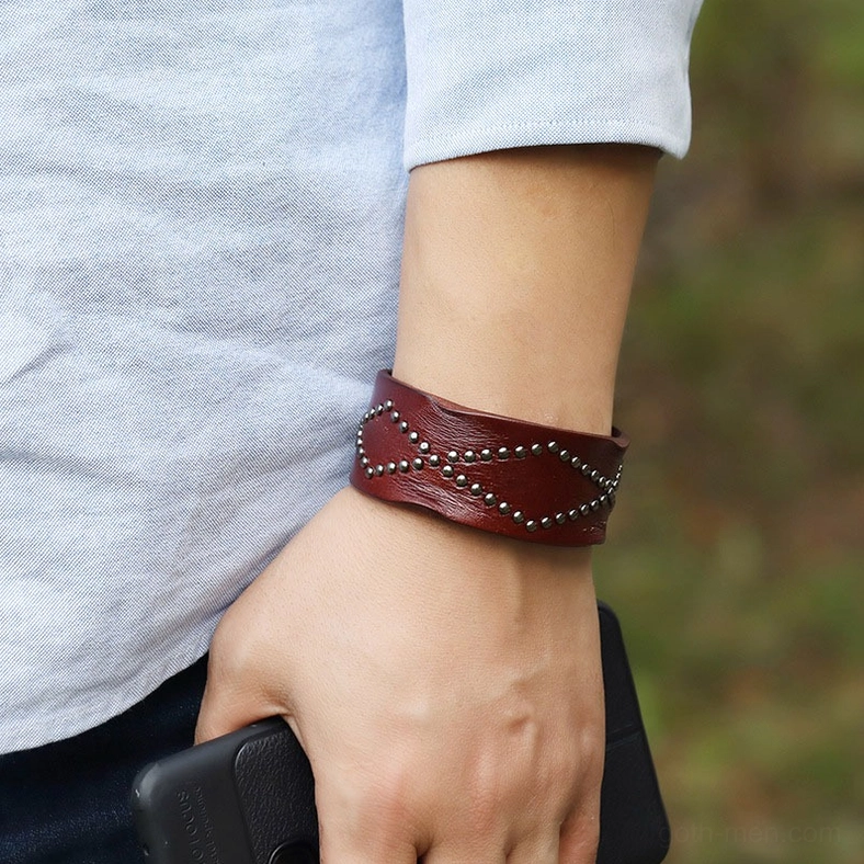 Genuine cowhide leather gothic cuff bracelet with industrial snap fastener and geometric cross rivet pattern