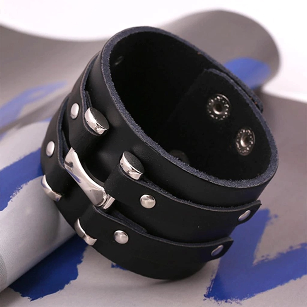 High angle side view of black leather gothic cuff bracelet with silver metal accents and stainless steel hardware