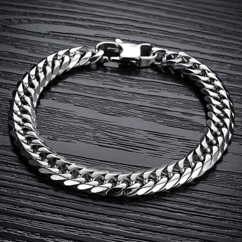 Stainless steel gothic chain bracelet overhead view on dark wood surface showing full chain design