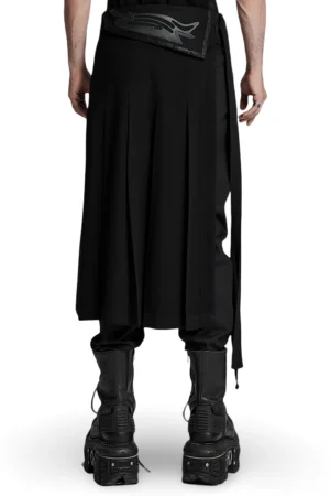 Black gothic pleated skirt with extended side straps and decorative waist buckles, rear full-body view on male model