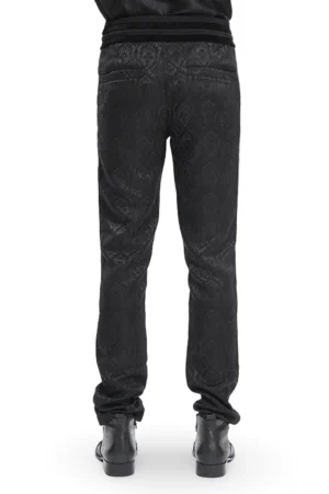 Black Gothic embossed pants rear view, male model displaying back silhouette of slim-fit damask pants with refined tailoring and sleek profile