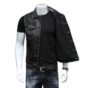 Men's sleeveless black denim gothic vest worn open over black tee, showing inner cotton lining and structured fit