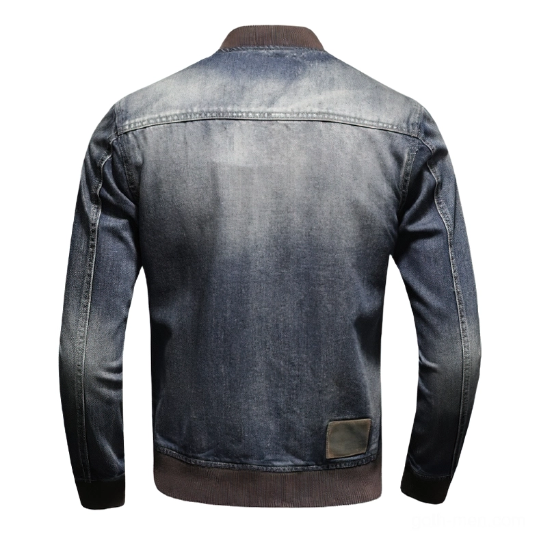 Standalone rear view of dark denim bomber jacket showing back leather patch and ribbed hem finishing