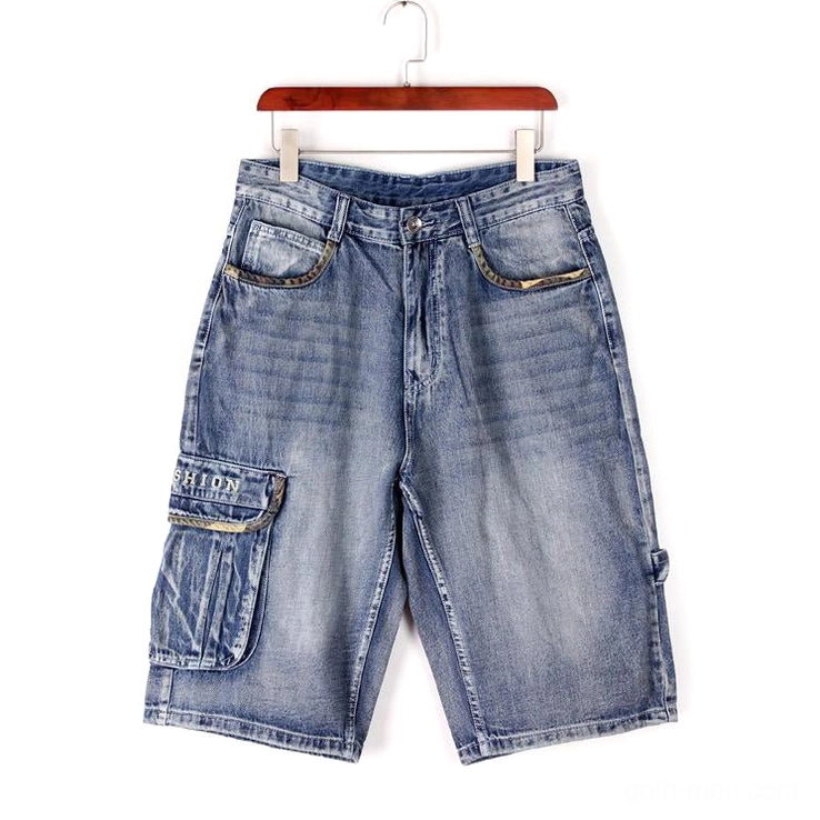 Men's loose fit baggy denim cargo capris flat lay on wooden hanger - faded indigo blue streetwear