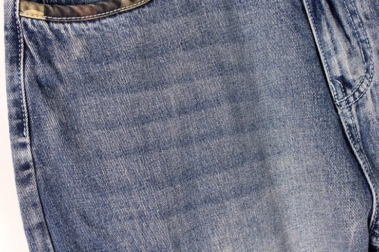 Gothic denim cargo capri shorts textured fabric close-up - faded indigo wash cotton denim quality
