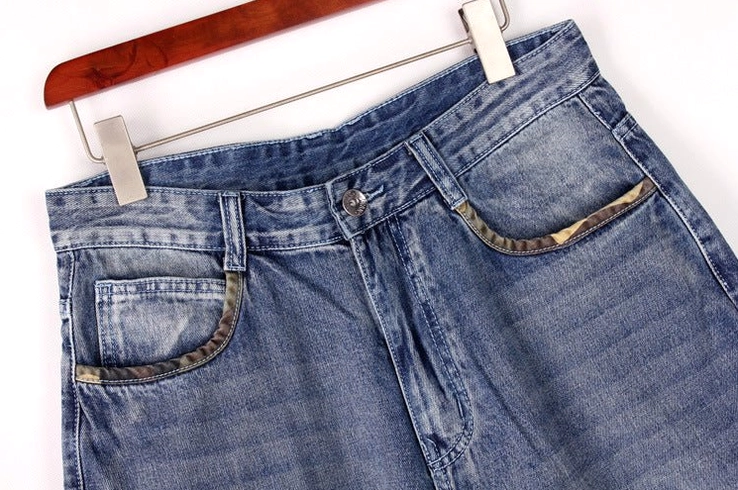 Denim capri shorts close-up detail - waist and pocket construction trimmed edges button fly closure