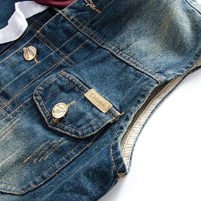 Denim vest chest pocket close-up - buttoned pocket with leather brand tag on faded vintage denim