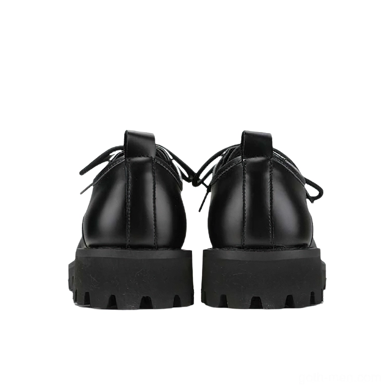 Rear view of black gothic platform boots showing heel pull tab and thick treaded outsole