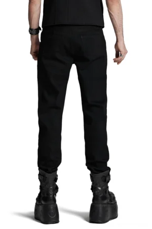 Black gothic denim pants with patchwork suede panels and back pockets, rear view on male model