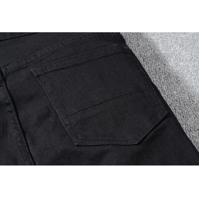 Full body front view of men's black gothic distressed slim jeans with rhinestone details on dress form