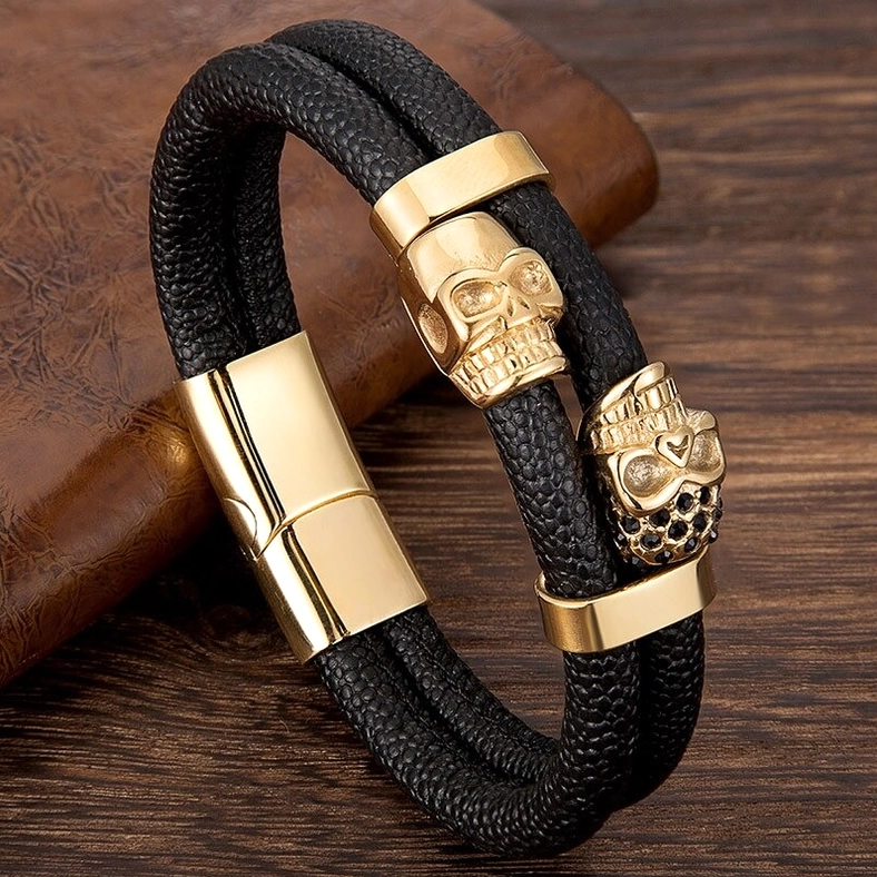 Gothic men's bracelet featuring double black skull decorations, genuine leather strap, and magnetic stainless steel closure