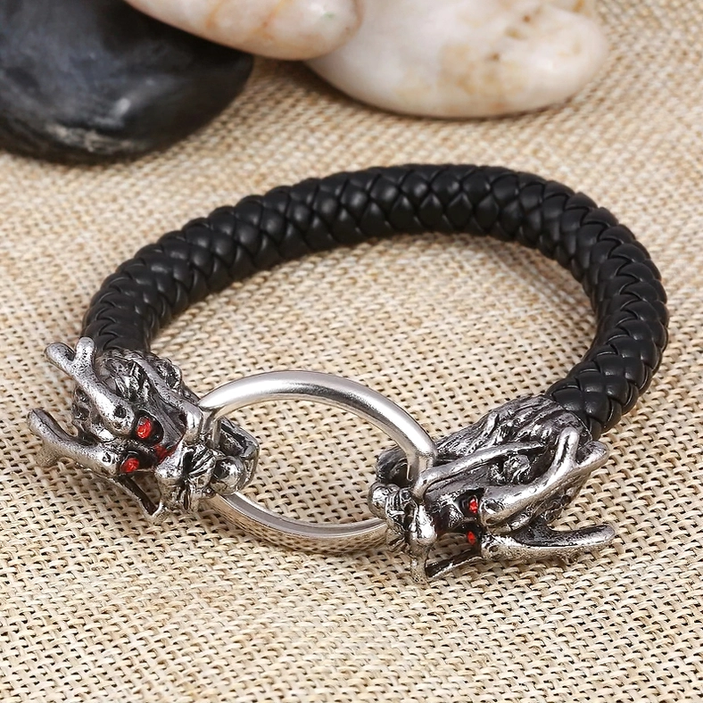 Dragon head gothic leather bracelet with silver metal clasp on burlap fabric - flat lay side view product photography