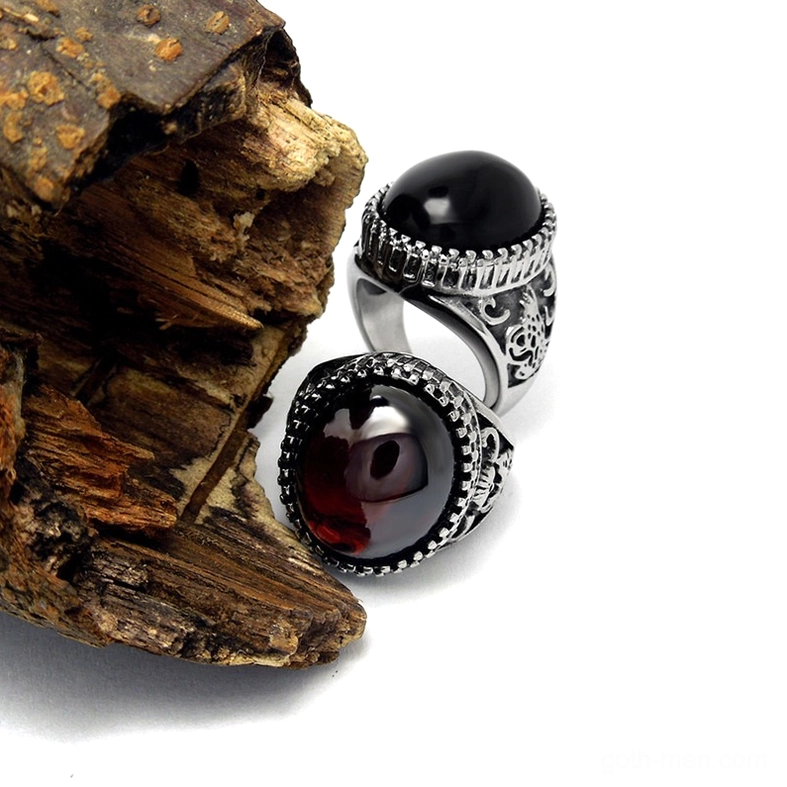 Gothic black and red stone rings side by side, detailed engraved stainless steel bands, alternative fashion jewelry