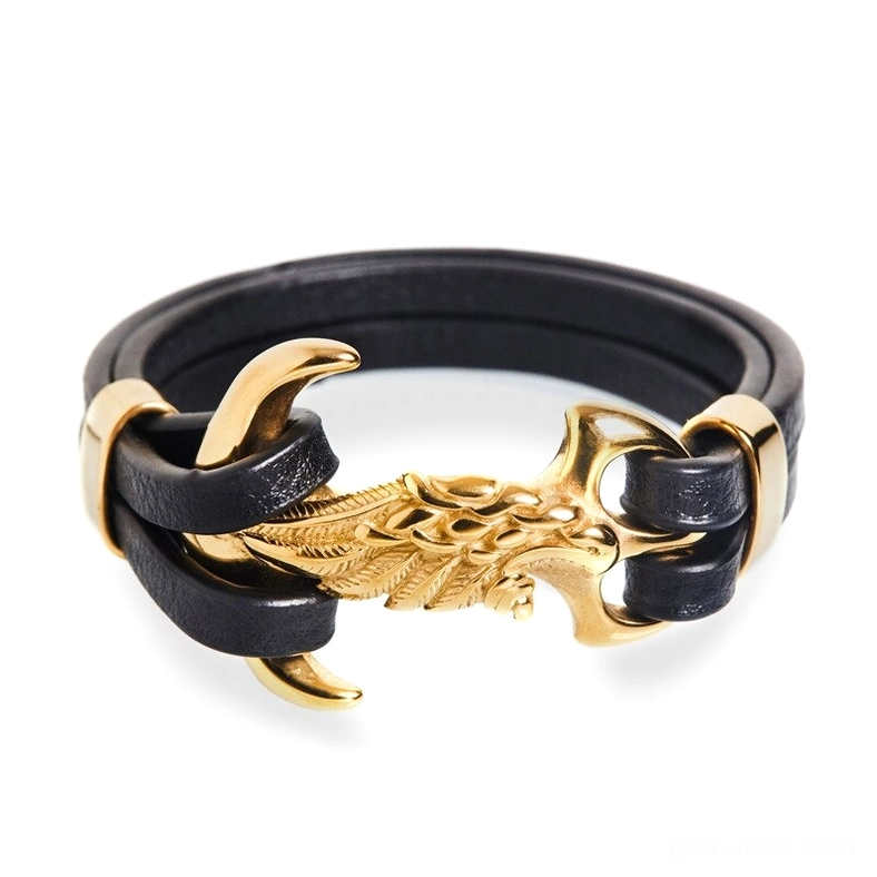 Gold eagle wing punk bracelet front flat lay showing full stainless steel hardware and black leather construction