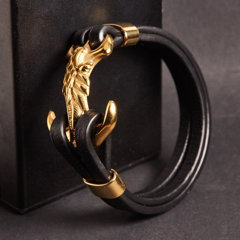Carved metal eagle gothic bracelet in dark studio lighting showcasing refined metal detailing and leather craftsmanship