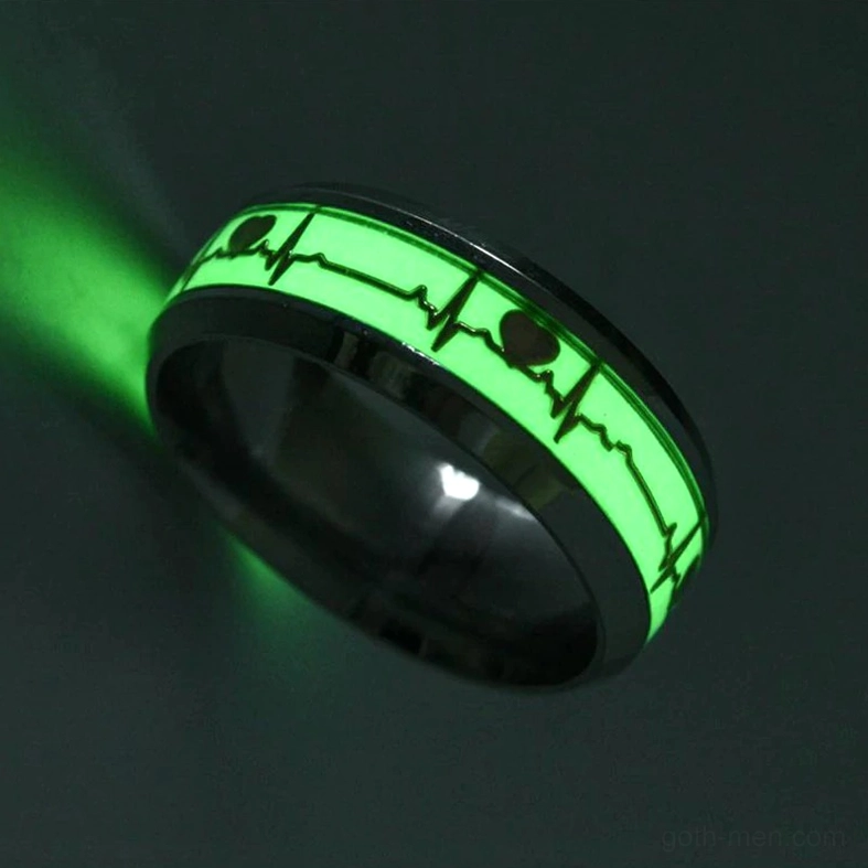 Single luminous stainless steel ECG ring with glowing green heartbeat pattern, side oblique view