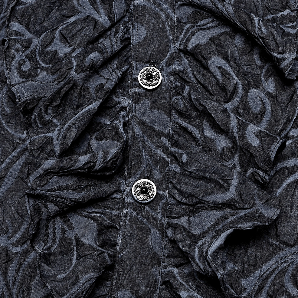Close-up detail of gothic shirt front placket showing gem-encrusted ornamental buttons and ruffled fabric