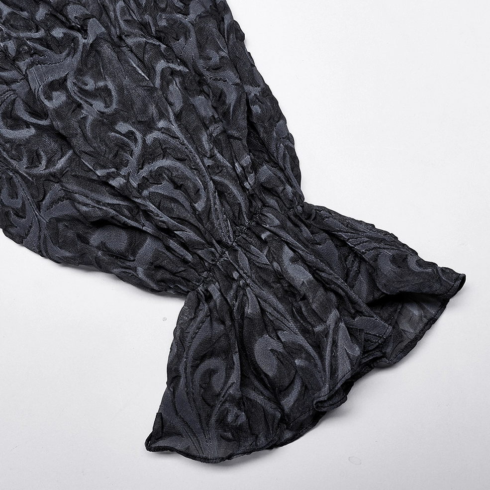 Close-up side view of gothic shirt cuff showing gathered bell sleeve and intricate scroll jacquard emboss pattern