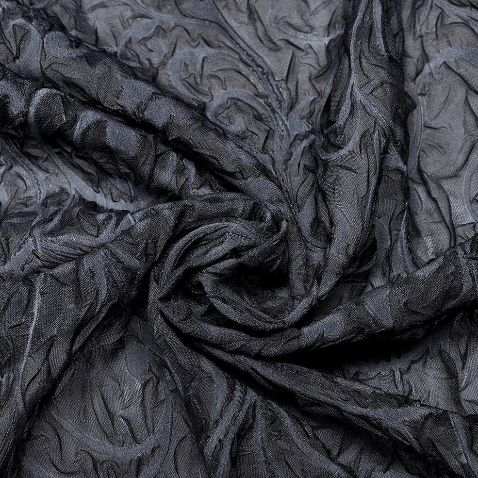 Fabric close-up of gothic embossed sheer chiffon showing raised texture and tonal scroll embossment detail