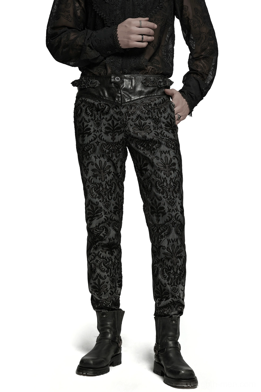 Front three-quarter view of black gothic embroidered lace slim-fit pants with leather waist strap on male model