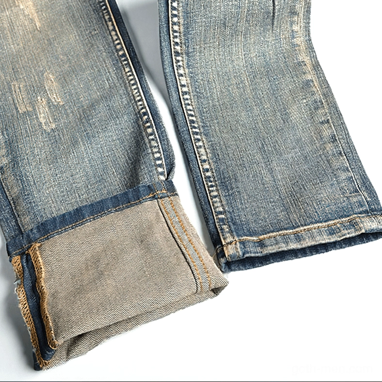 Full product lifestyle shot of men's gothic embroidered ripped denim jeans in alternative dark style, complete sizing and style reference