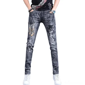 Front view of men's gothic dragon embroidered skinny jeans in grey washed denim with intricate thigh embroidery