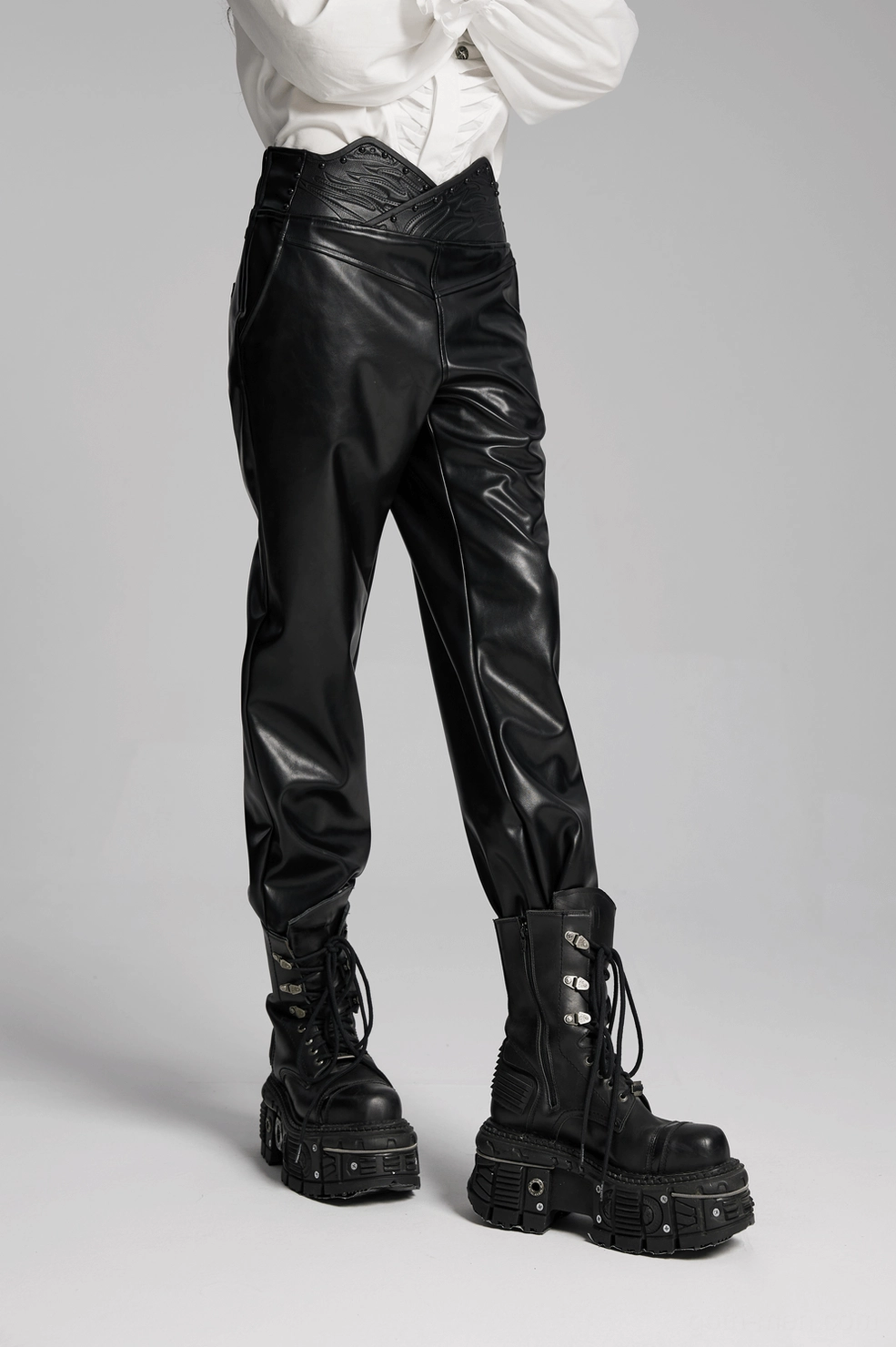 Black faux leather pants fabric texture close-up, glossy PU leather finish with slight elastic quality