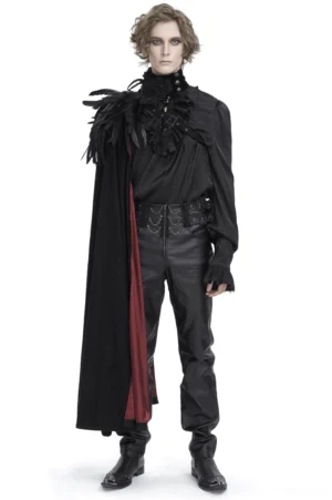 Male model wearing black feathered asymmetric gothic cape with wine-red lining, front full-body view in studio setting