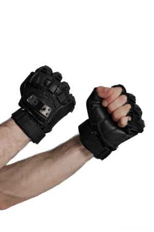 Close-up of clenched fists wearing gothic spiked armor gloves, showing hard shell protection and black leather panels