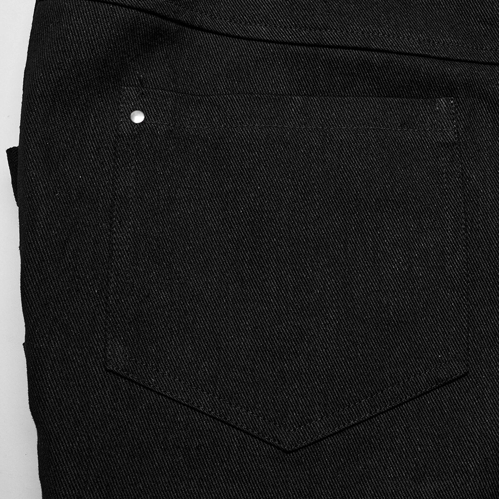 Back pocket close-up showing metal rivet trim and black twill fabric texture