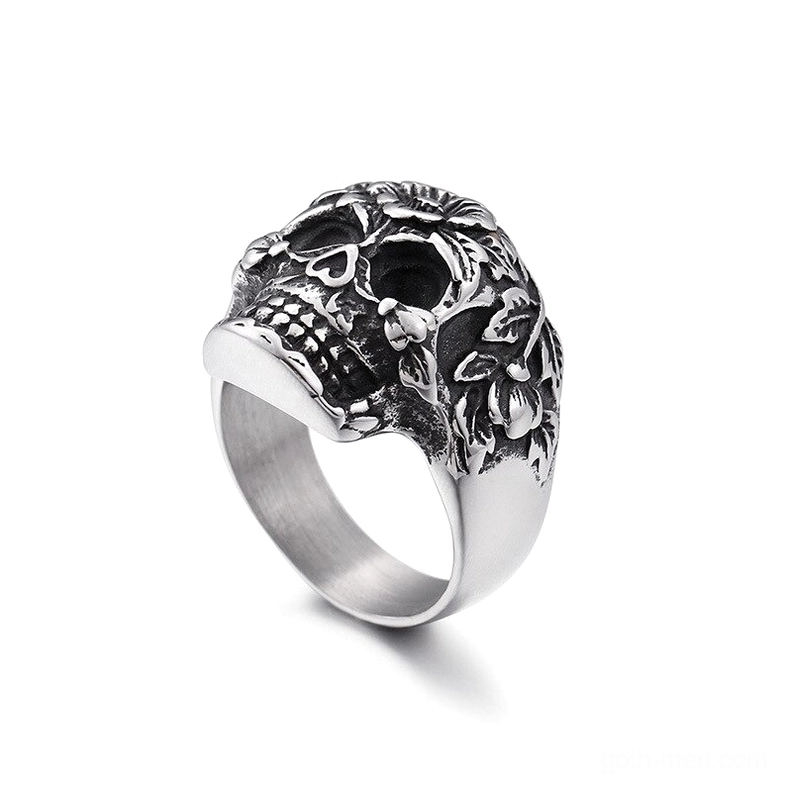 Vintage silver skull ring with floral engravings side profile view, smooth band detail, distressed patina finish