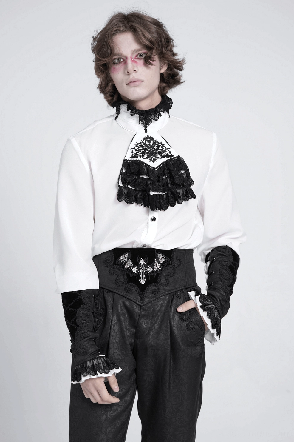 Macro front close-up of gothic arm gauntlet showing crisscross embroidered trim, ruffled lace cuffs, and fine velvet fabric detail on white background
