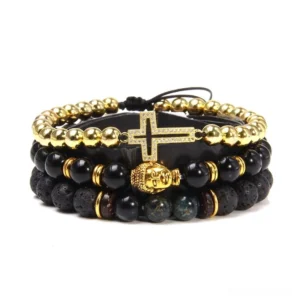 Gold-tone and black stone layered gothic bracelet with cross charm, Buddha head decoration, and mixed natural stone beads, studio flat lay