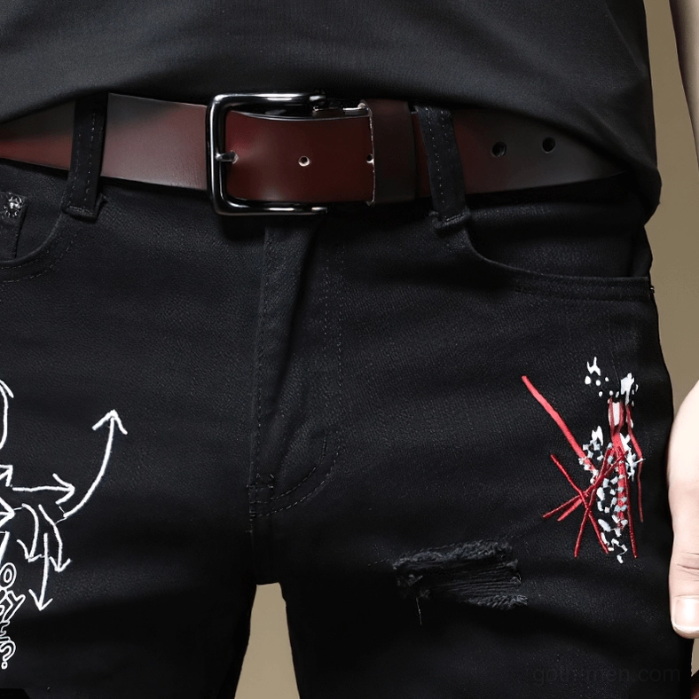 Black and white gothic ripped jeans detail shots showing graffiti prints and distressed craftsmanship
