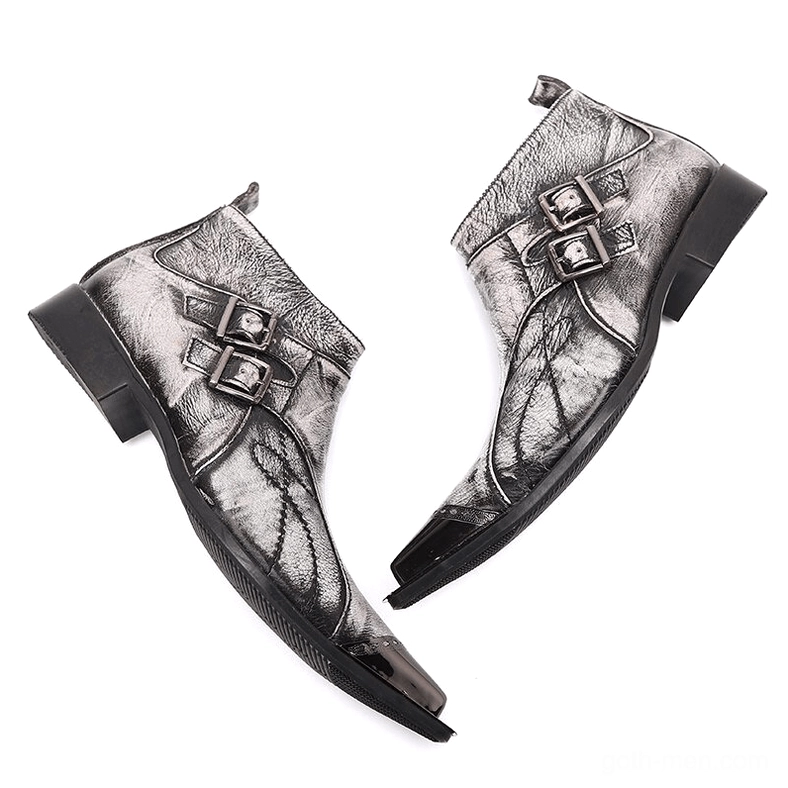Pair of grey leather gothic boots with dual buckles, distressed texture, and black rubber sole, bottom angle