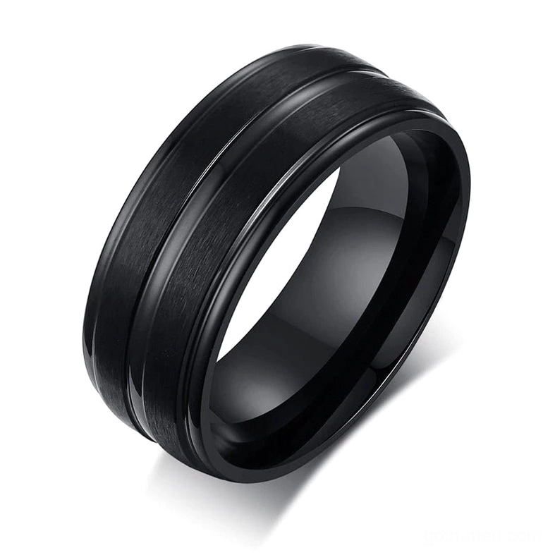 Black matte stainless steel gothic groove ring with geometric pattern, oblique top-down view on white background