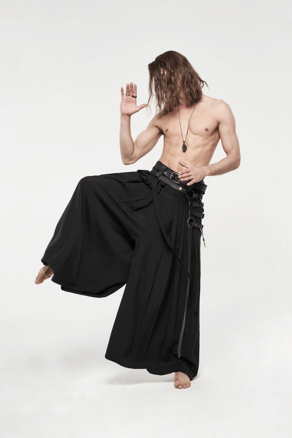 Black gothic hakama pants leather strap arrangement and metal d-ring placement showing punk rock aesthetic hardware design
