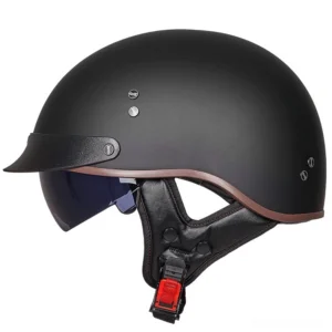Black vintage half-face gothic motorcycle helmet with matte finish and metal rivet details, front three-quarter view showing UV-protected visor