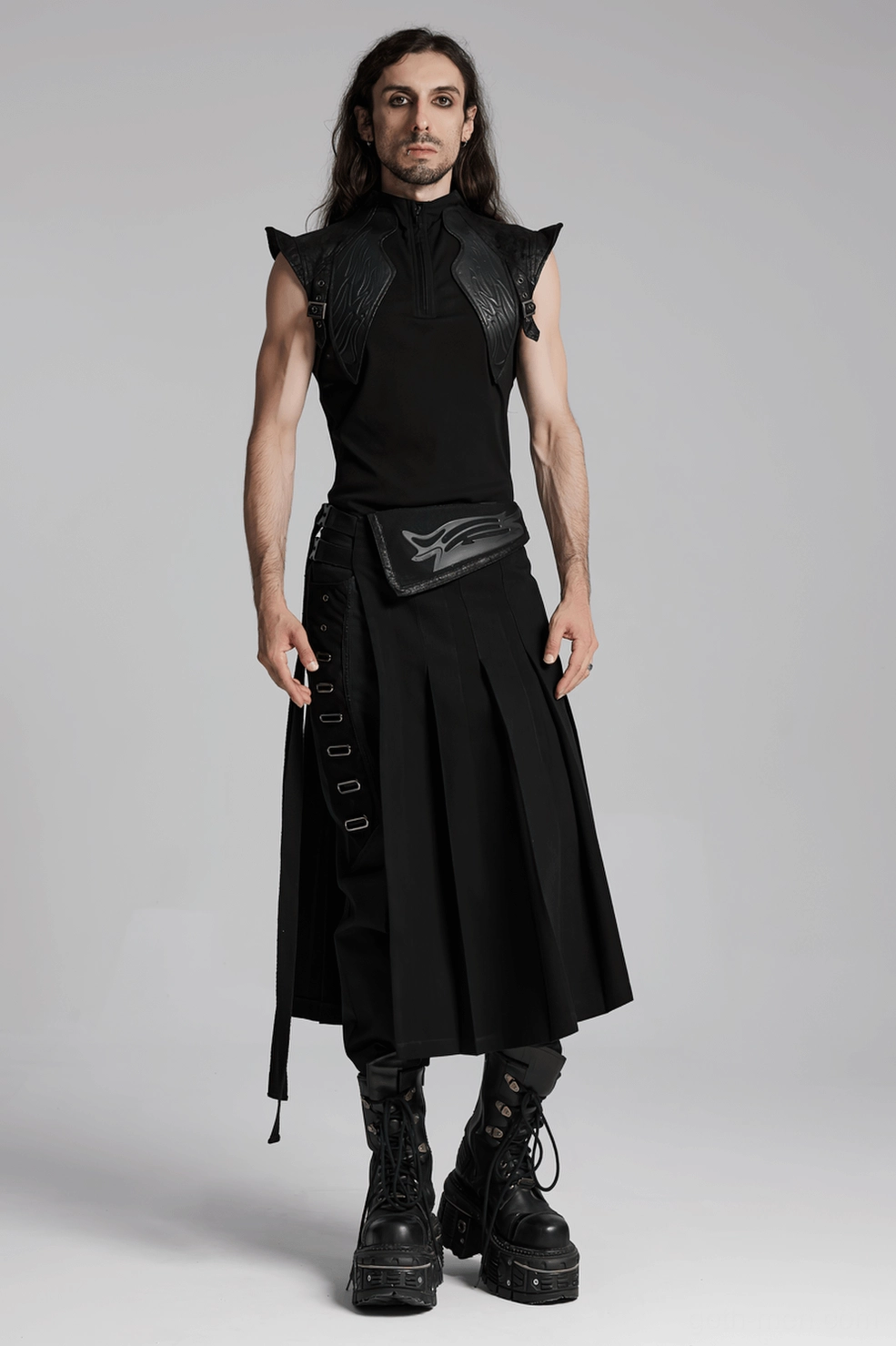 Black gothic pleated half skirt showing full length profile with side hanging straps and embossed details