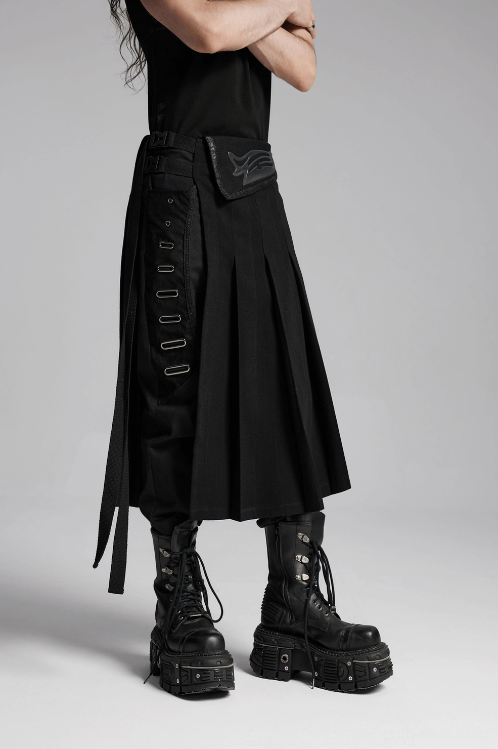 Black gothic pleated half skirt interior construction showing waist panel assembly and hardware