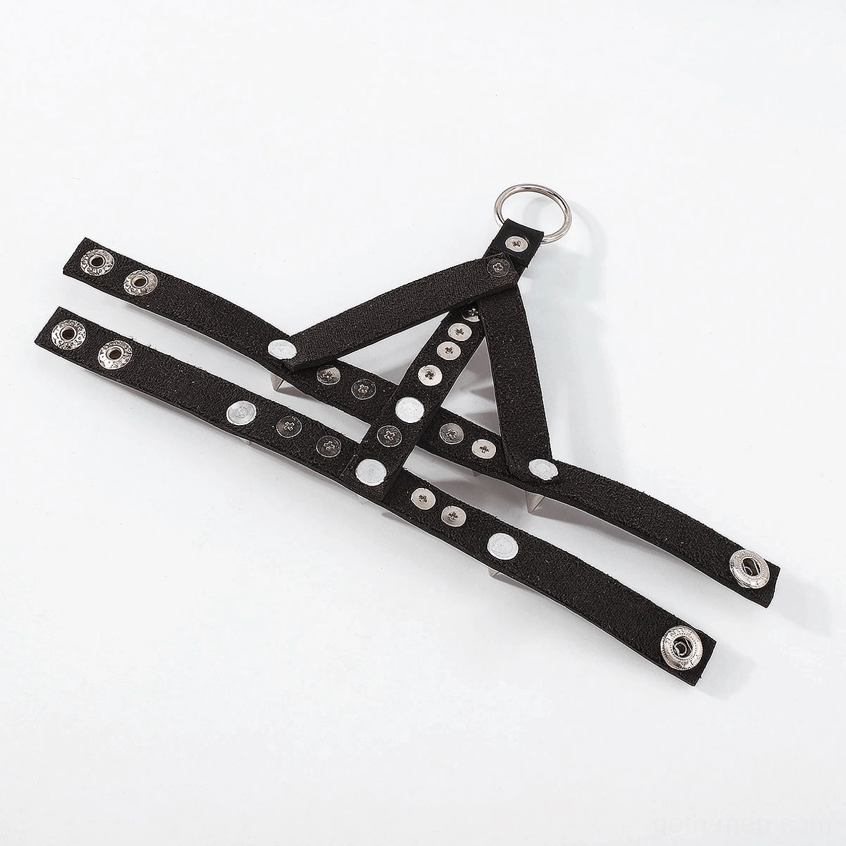 Overhead flat lay of Y-shaped detachable spiked bracelet straps with round metal decorative studs on white background