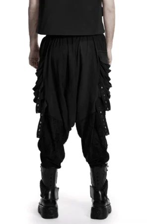 Black gothic harem pants rear view showing ruched side panels, metal rivet trims, and drop-crotch silhouette on model