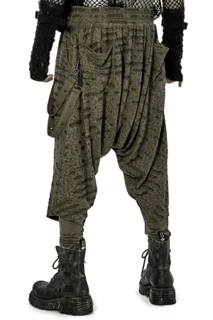 Olive green urban goth harem pants rear view on male model, showcasing elastic waist, deep side pockets, and avant-garde silhouette