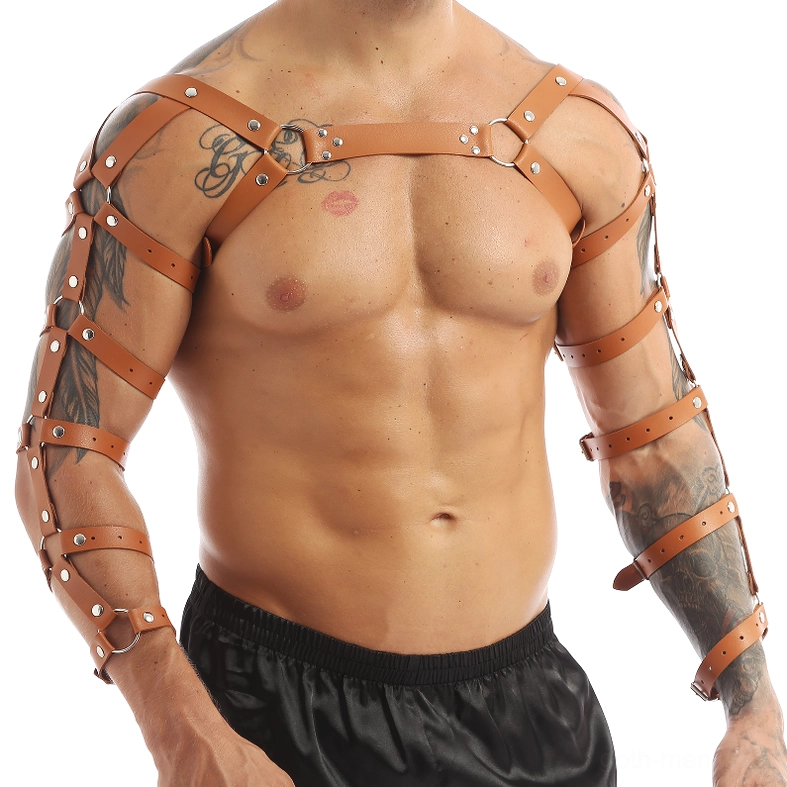 Muscular tattooed man wearing brown gothic leather harness front view chest cross straps detail