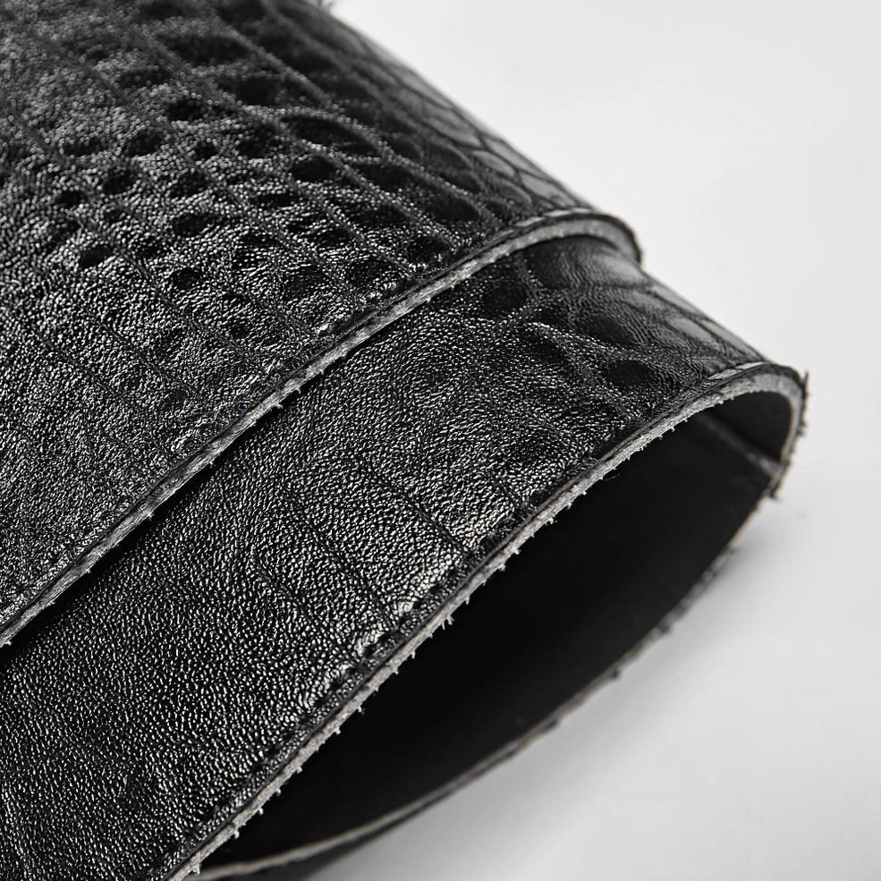 Detailed side macro view of pebbled black PU leather texture with stitched edges on gothic armor harness