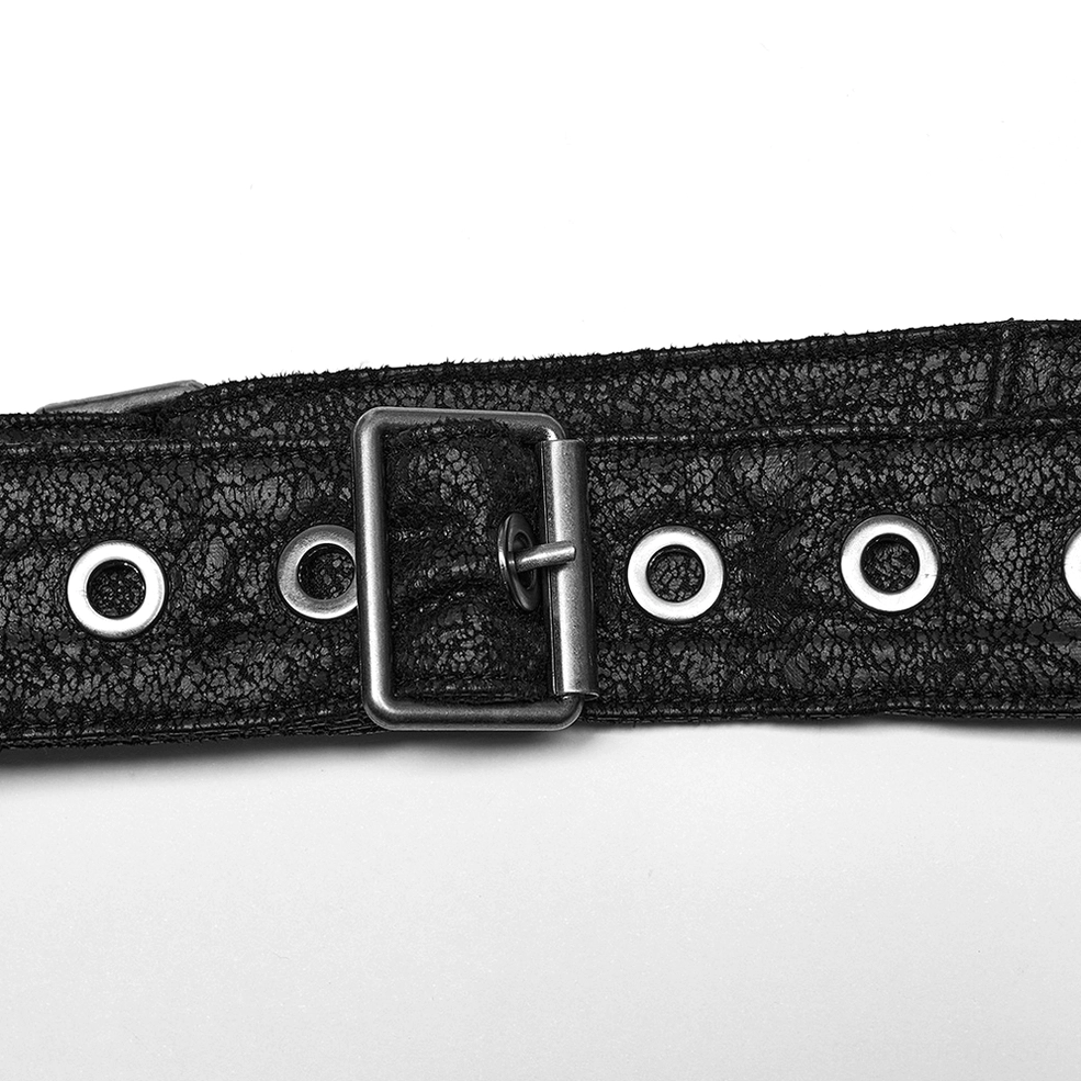 Flat lay close-up of square black metal buckle on cracked faux leather belt with perforated grommet holes